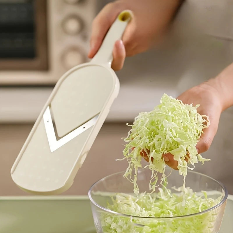 Handheld vegetable slicer shredding cabbage straight into a glass bowl